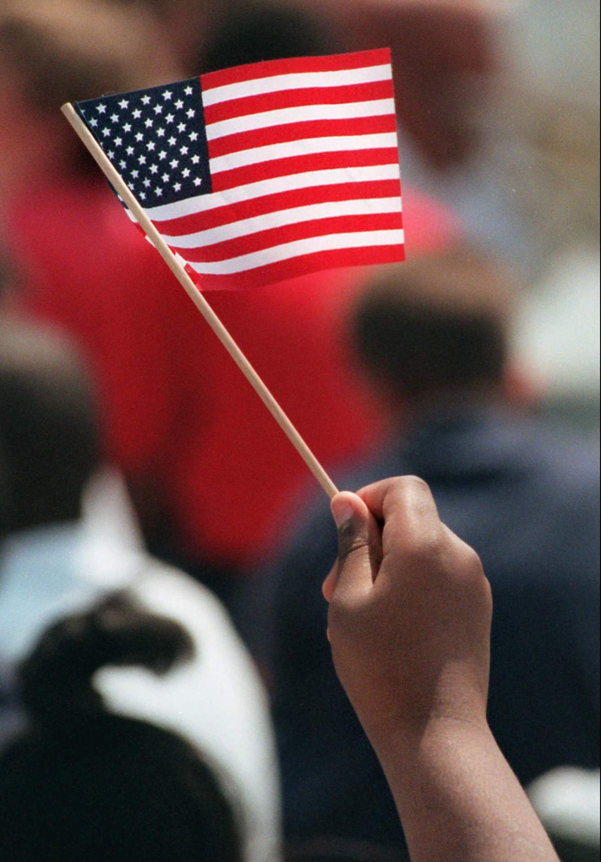 Kid hand holding American flag